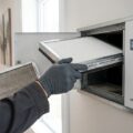 Person udskifter hvidt luftfilter i moderne ventilationsanlæg til smart home-system